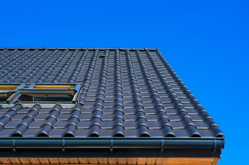 Professional painter restoring and painting a metal roof in Toowoomba