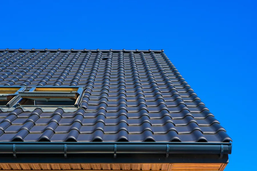 Professional painter restoring and painting a metal roof in Toowoomba
